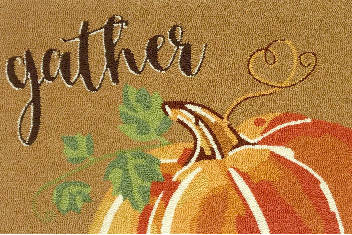 A rectangular area rug with a text 'GATHER' in cursive script, accompanied by a pumpkin and leaves design, suggesting a fall or harvest theme.